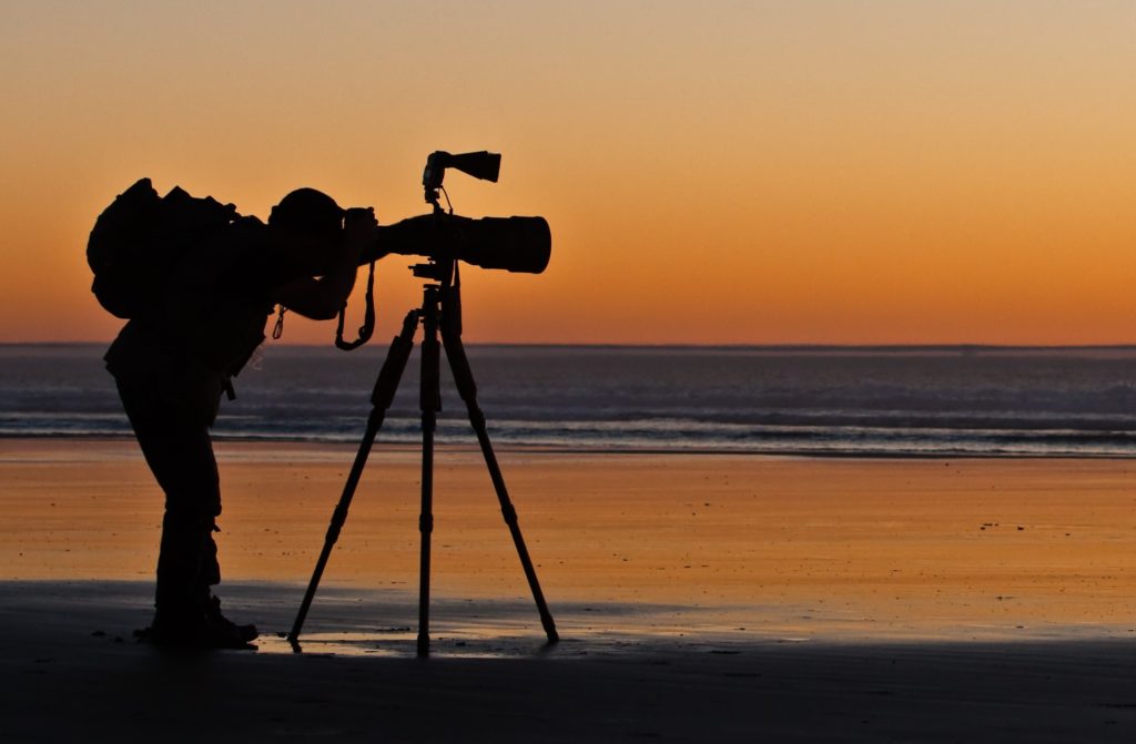 Photographer at taking pictures at twilight