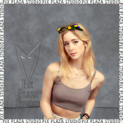 A photo of a young woman posing for the camera in Pix Plaza studio